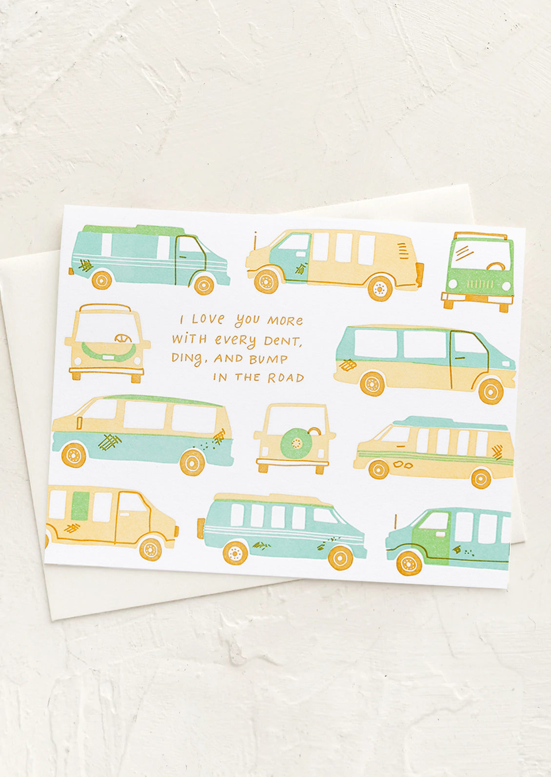 A card with cars print and text reading "I love you more with every dent, ding and bump in the road".