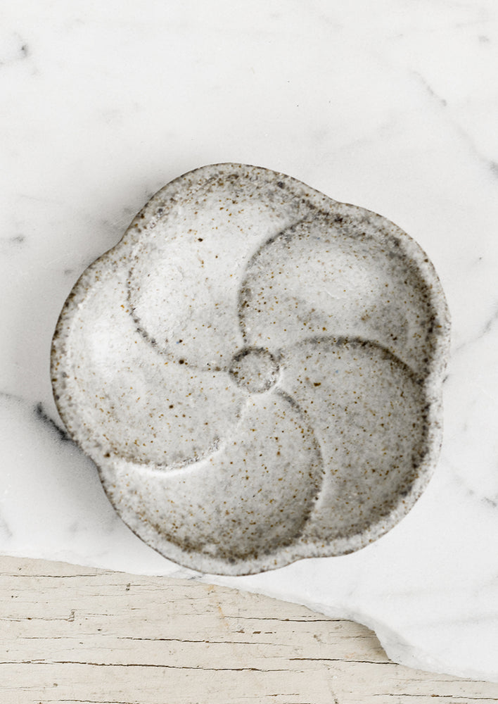 1: A round ceramic dish in shape of the flower, speckled grey glaze.