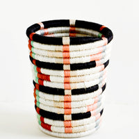 Peach Multi: Pencil cup shaped baskets woven from multicolor sweetgrass. Mix of pastel colors in a geometric pattern.