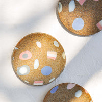 2: Scattered ceramic trinket dishes with various inlay shapes.