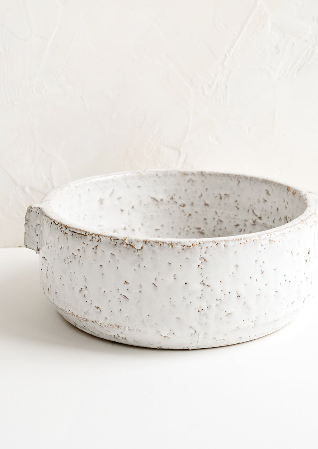Large: A round white serving bowl in textured glaze.