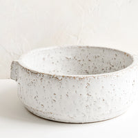 Large: A round white serving bowl in textured glaze.