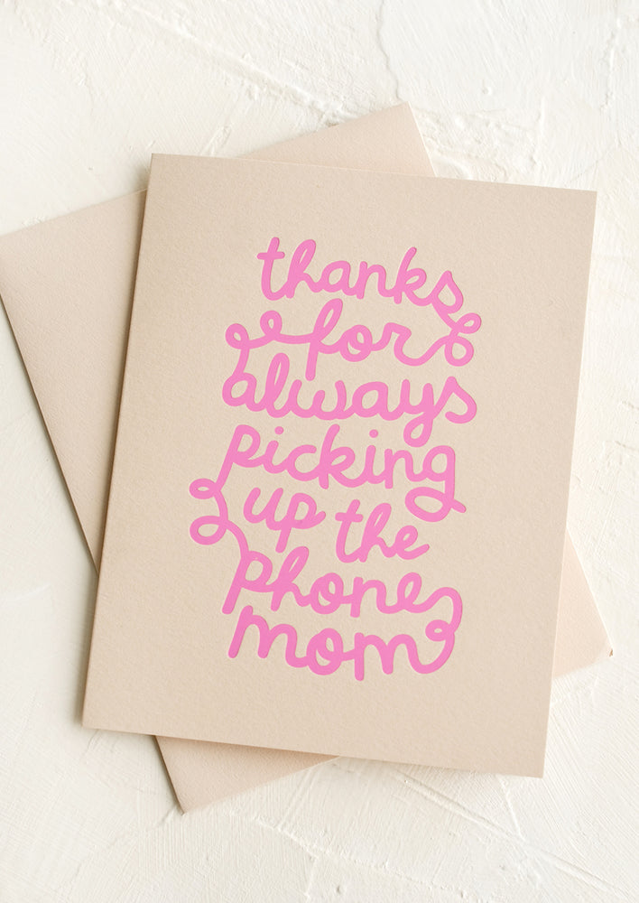 A beige greeting card with pink text reading "Thanks for always picking up the phone Mom".
