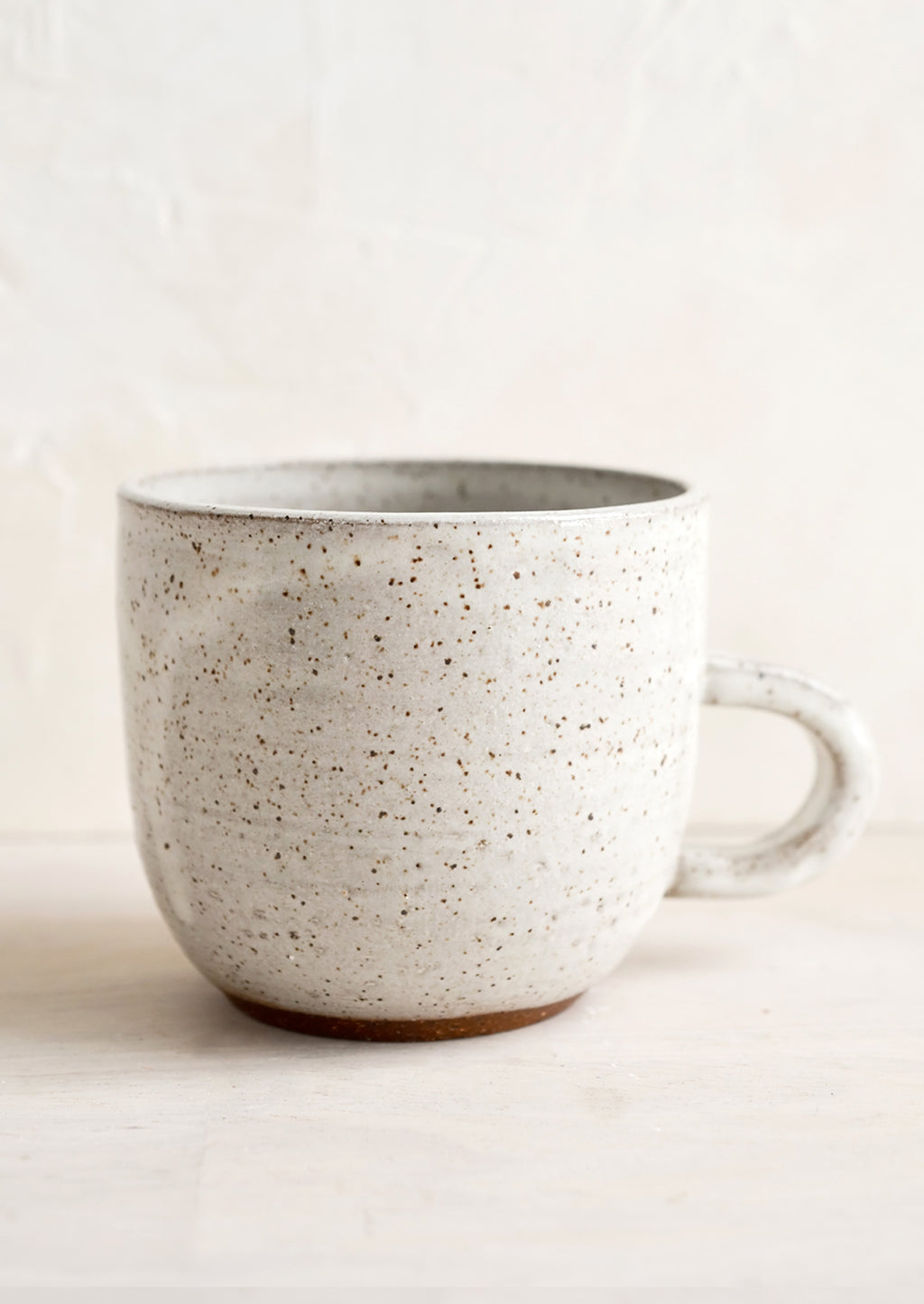 Aquinnah Speckle (Glossy): A short ceramic coffee mug in glossy natural glaze with brown speckles.