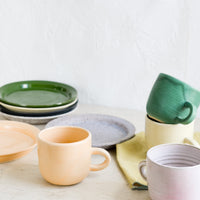 10: A mix of hand glazed plates and mugs.