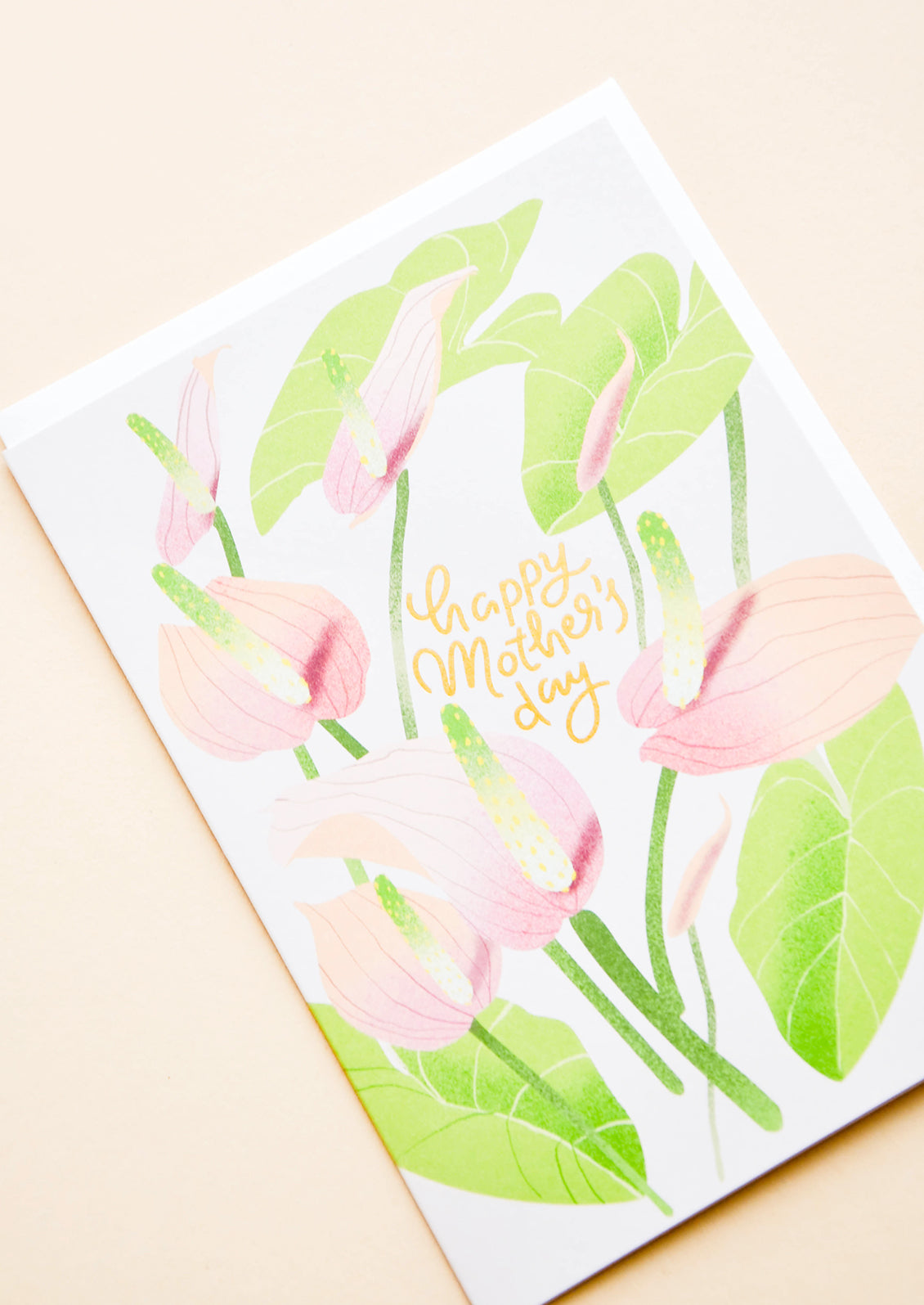Greeting card with painted florals and "Happy Mothers Day" written in gold.