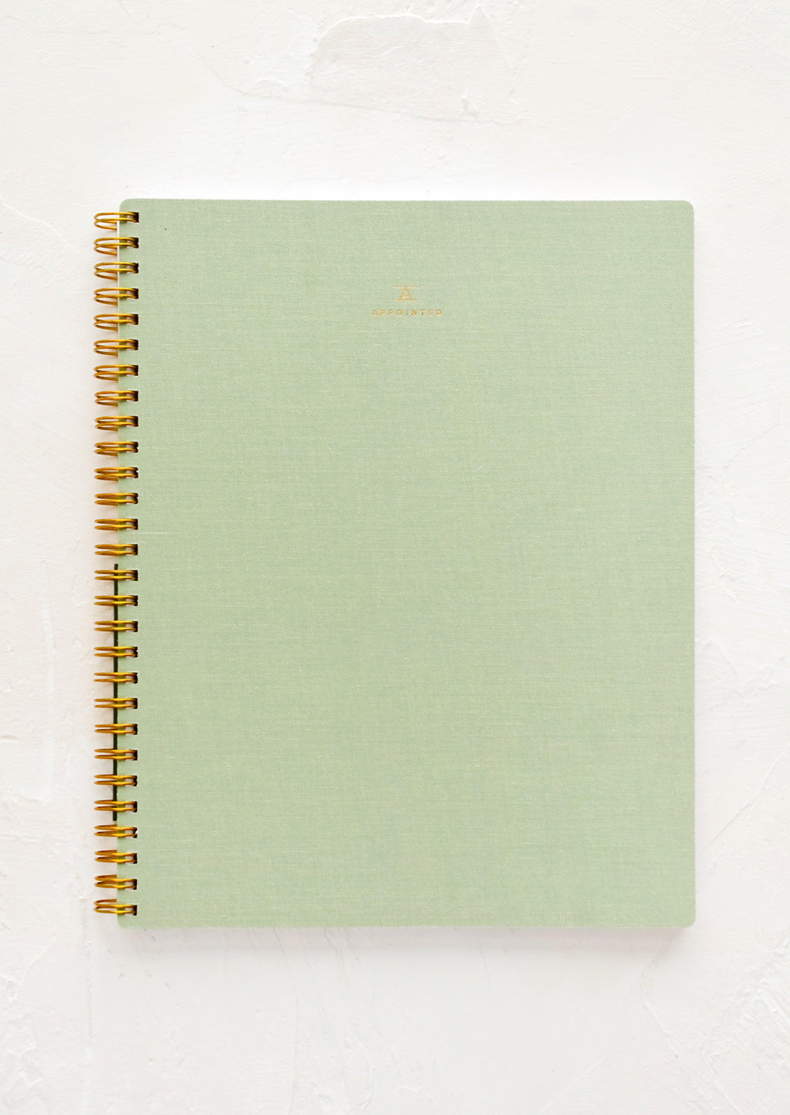 A spiral bound notebook in green.