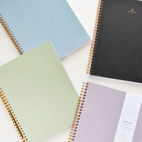 Charcoal: Four spiral bound notebooks in assorted colors.