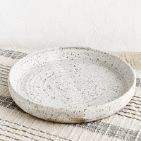 Speckled White: A shallow serving plate in speckled white.