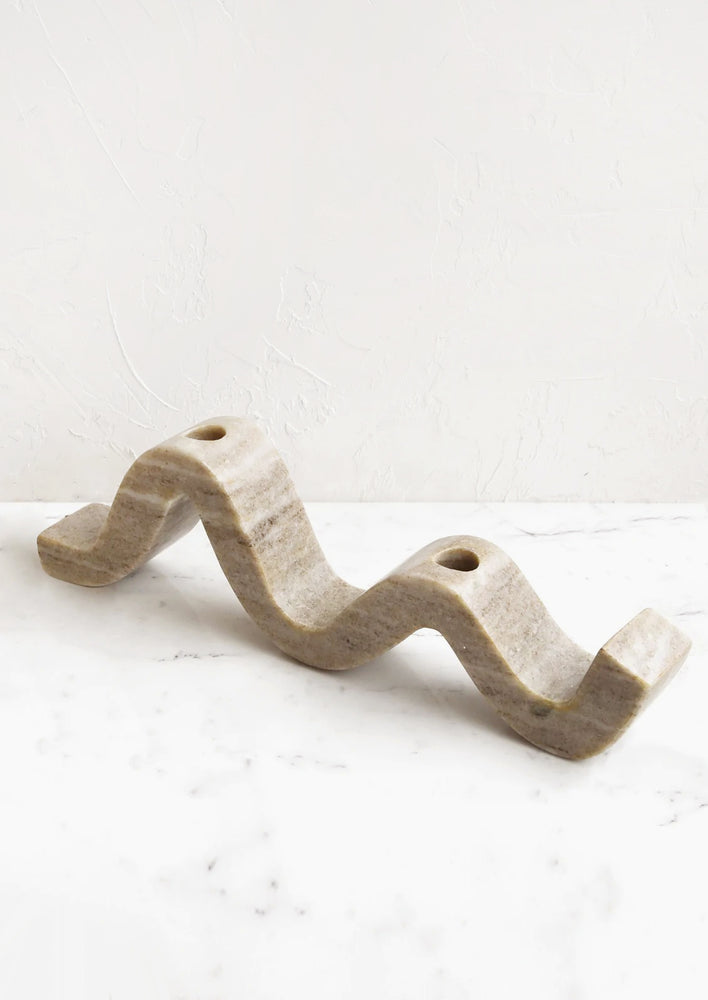Default Title: A tan marble candleholder for two candles, in a wavy shape.