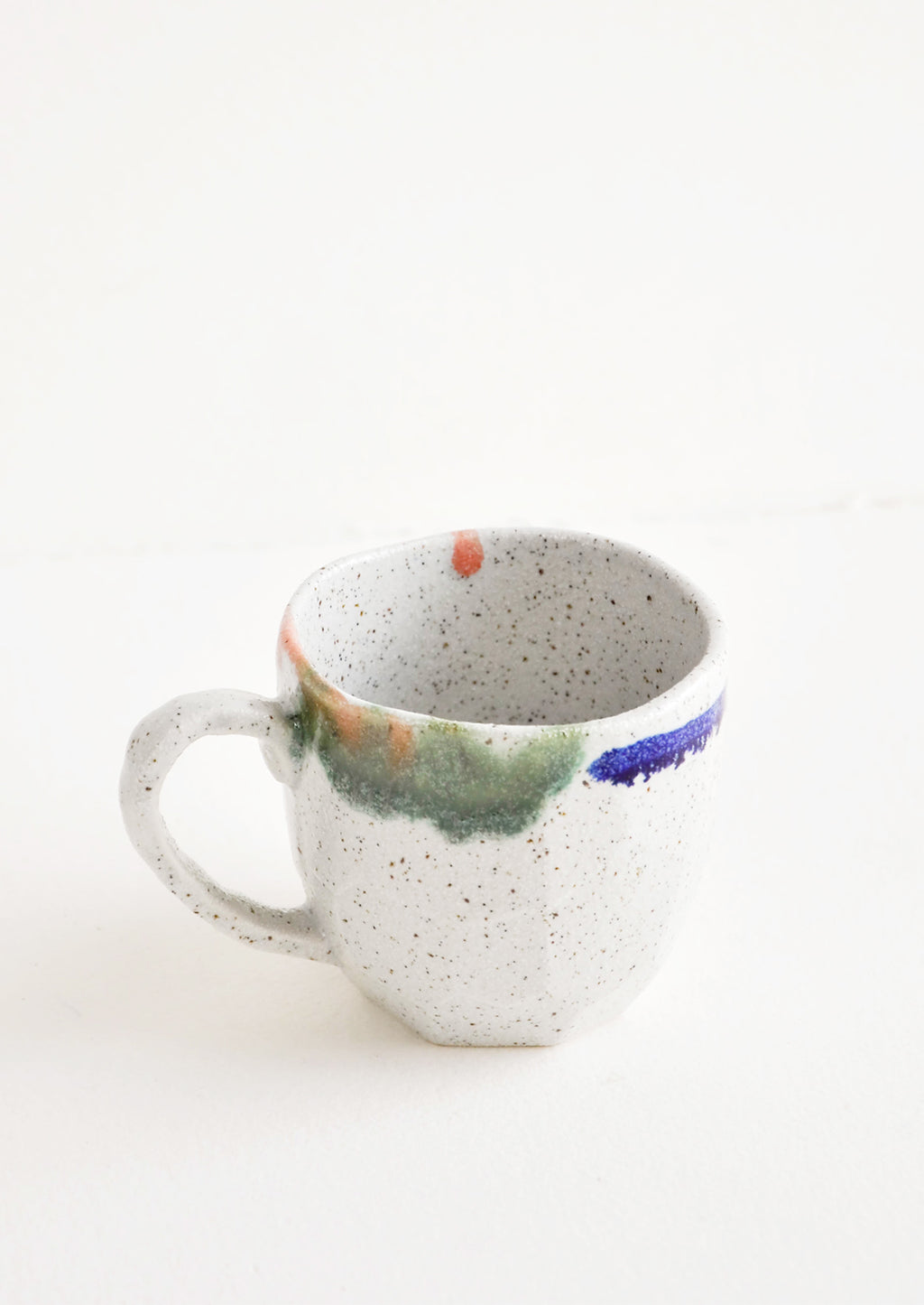 8 oz [$22.00]: A short gray ceramic mug with blue, green, and pink painted rims.