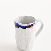 12 oz [$24.00]: A tall gray ceramic mug with blue, green, and pink painted rims.