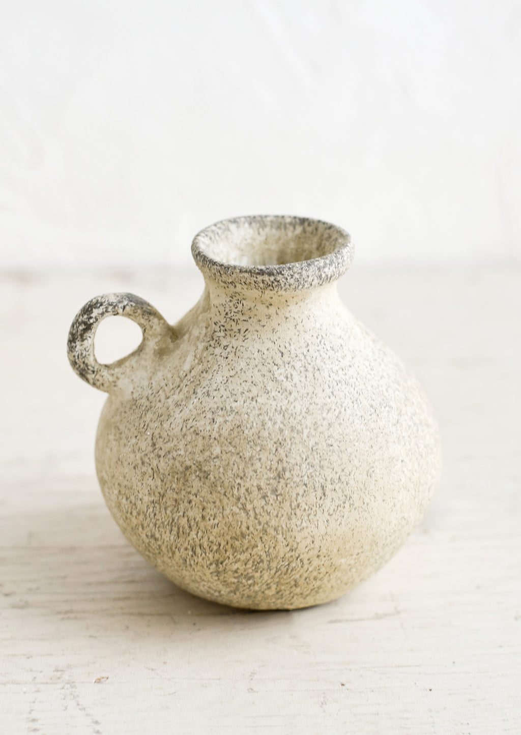 2: A petite ceramic bud vase in tan patina finish.