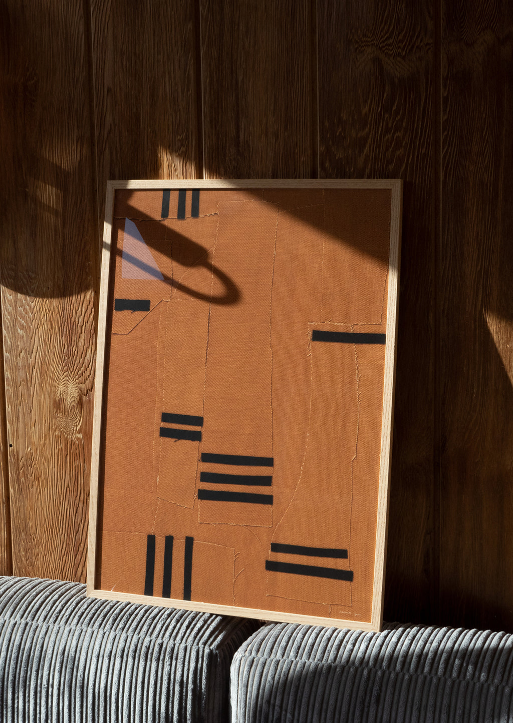 2: An art print of photographed brown textile with bold black line detailing.