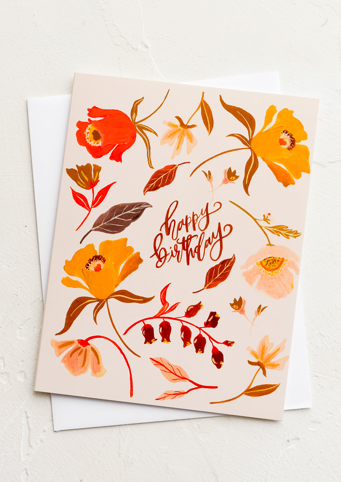 A greeting card with florals in peach, red and orange.