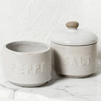 2: Stackable white ceramic salt and pepper jar with lid.