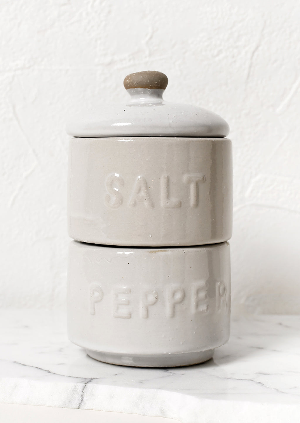 1: Stackable white ceramic salt and pepper jar with lid.