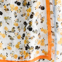 3: A floral print scarf with orange and blue border.