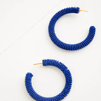 Lapis: Thick hoop earrings of lapis colored glass beads.