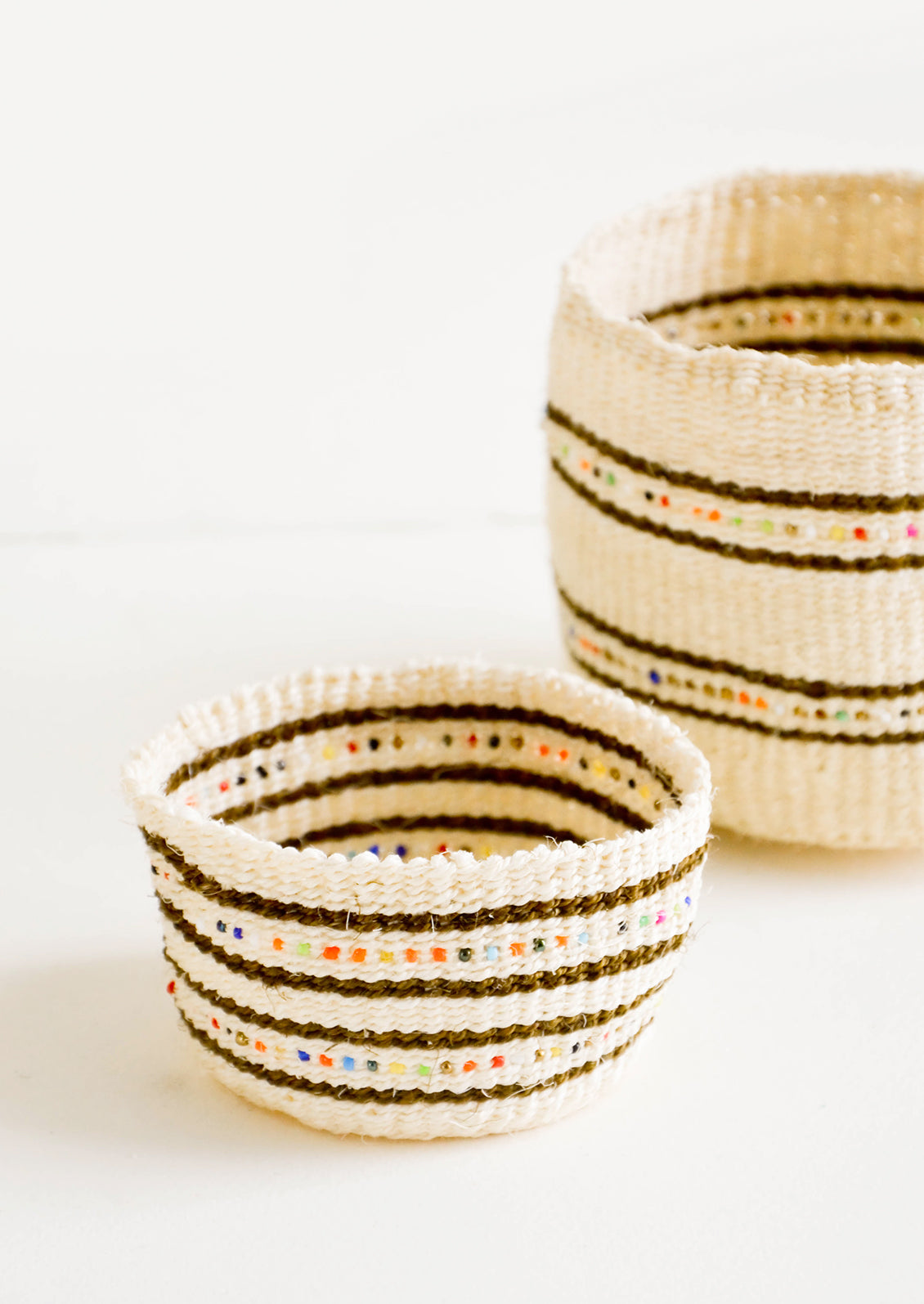 Natural sisal grass baskets in two sizes with stripes and rainbow beading