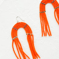 Flame: Arch shaped beaded earrings with fringed silhouette in flame orange.