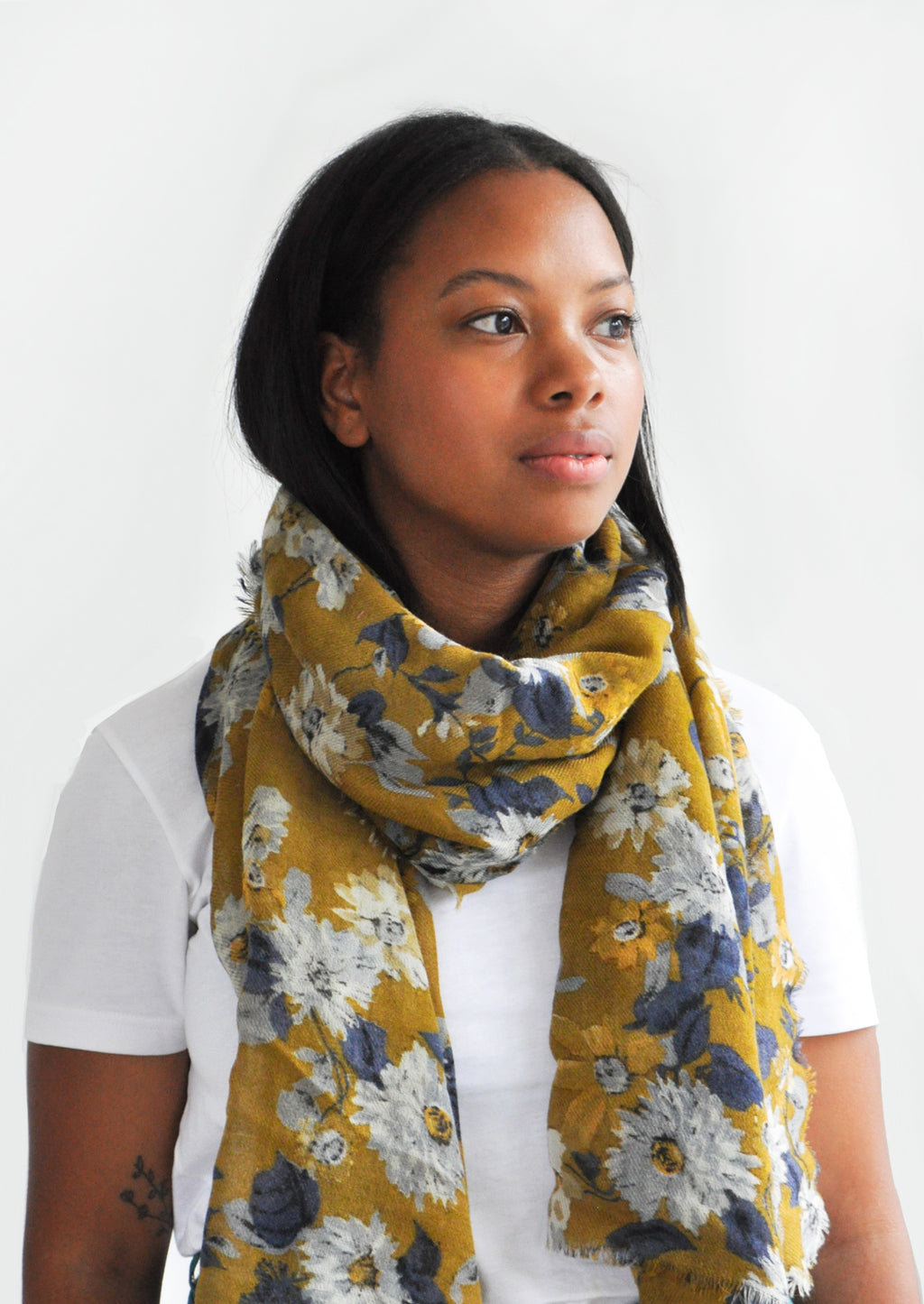4: Product shot of woman wearing scarf and white top.