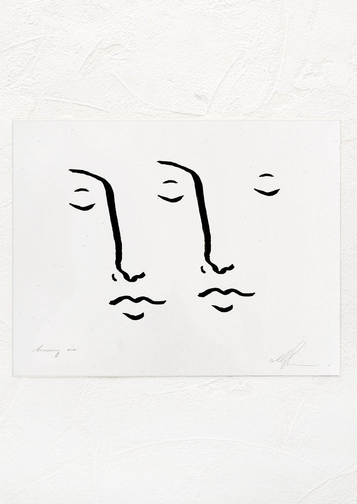 1: A black and white art print with drawing of two faces together.
