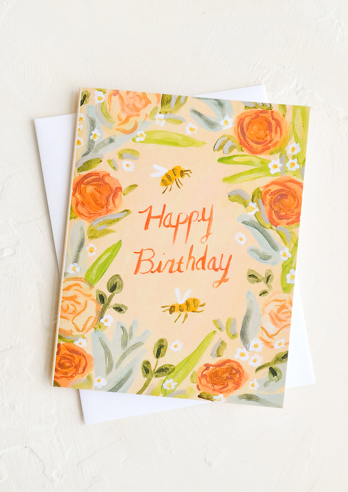 A birthday card with floral and bee illustration reading "Happy birthday" at middle.