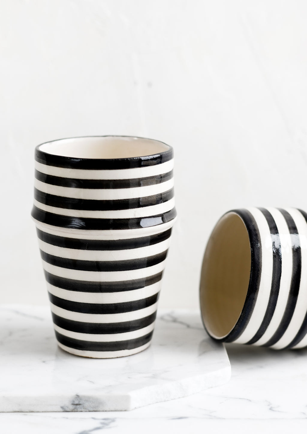 Black: Two moroccan Beldi cups in striped black ceramic.