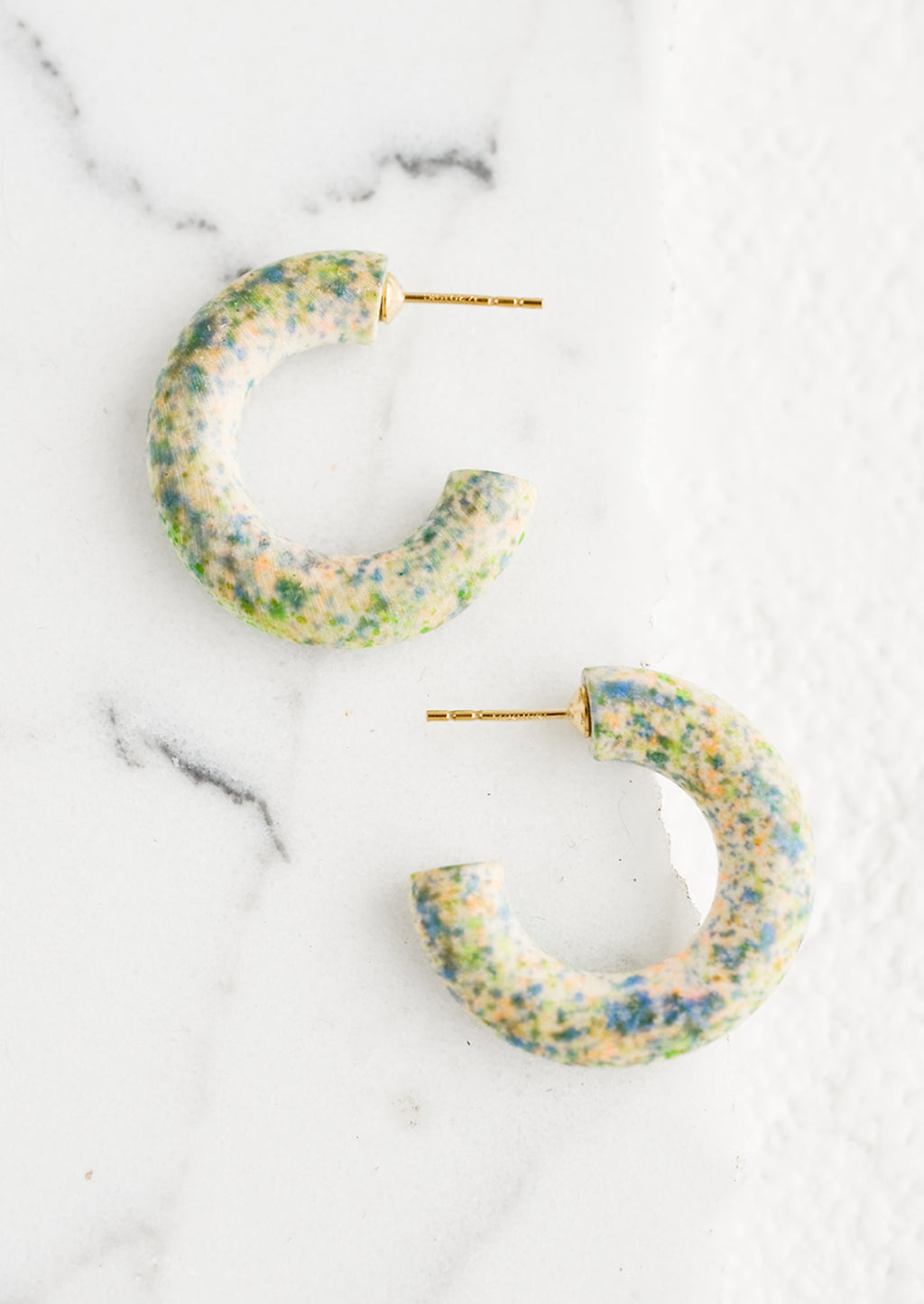 Valley Tie Dye: A pair of painted wood hoop earrings in speckled pattern.