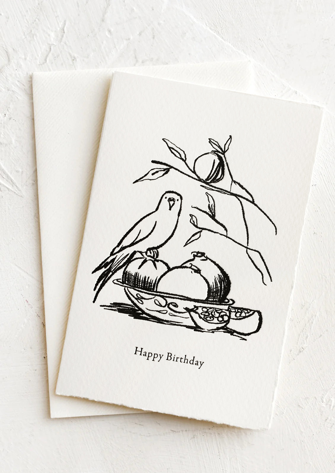 A card with illustration of parakeet and bowl of fruit, text reads "Happy Birthday".