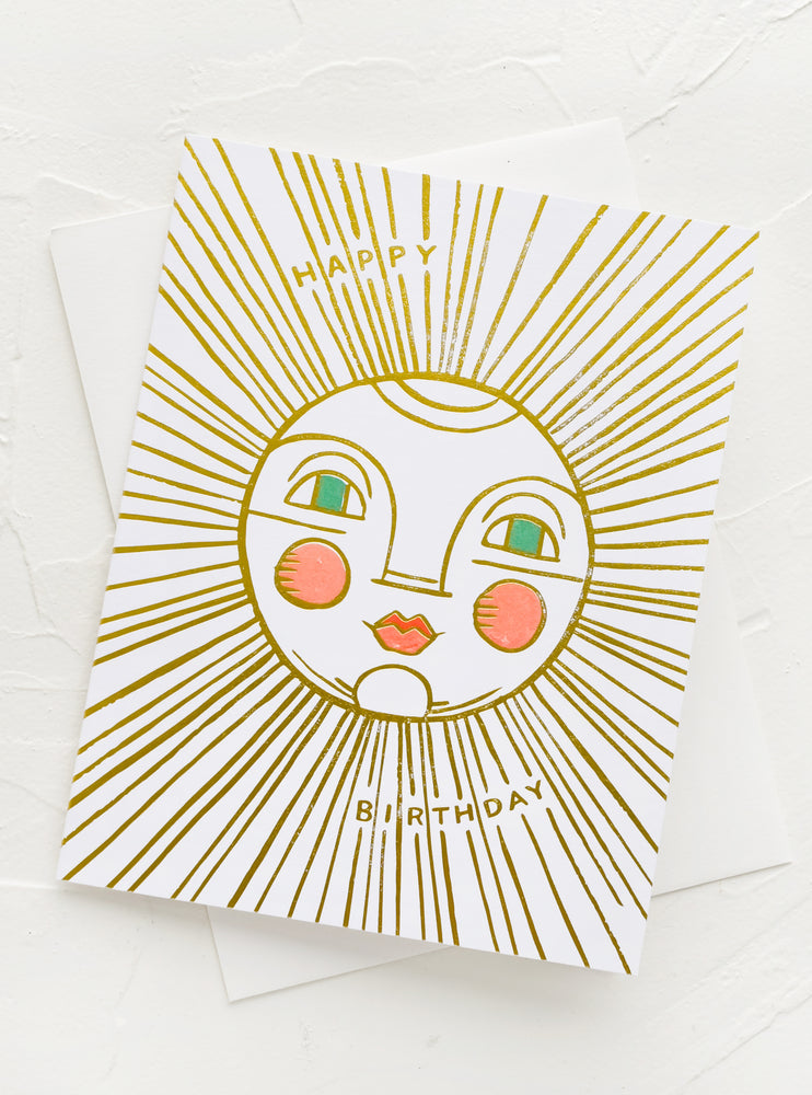 A birthday card with illustration of sun with face, text reading "Happy Birthday".