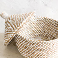 1: Woven storage basket made from natural grass with white checkered pattern