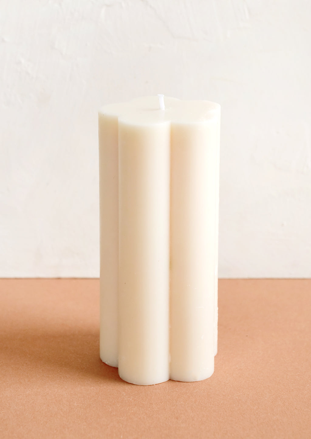Ivory: A flower shaped pillar candle in off white.
