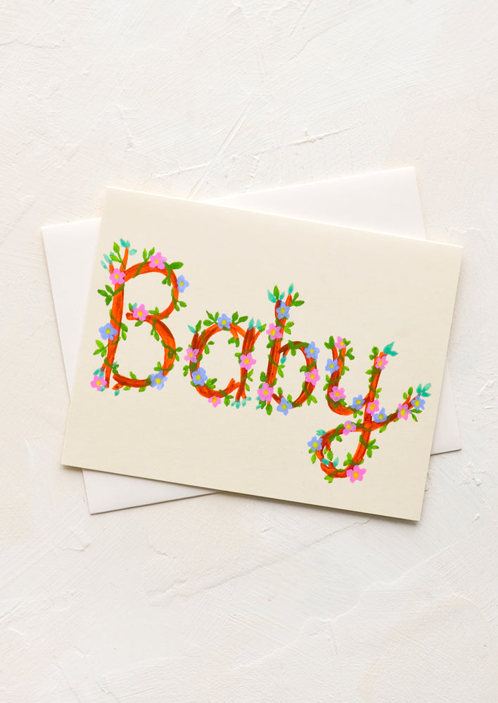 1: A greeting tag with "baby" written in floral cursive.
