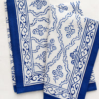 1: A pair of blue and white floral block print napkins.