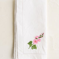 Foxglove: A white cotton napkin with foxglove embroidery.