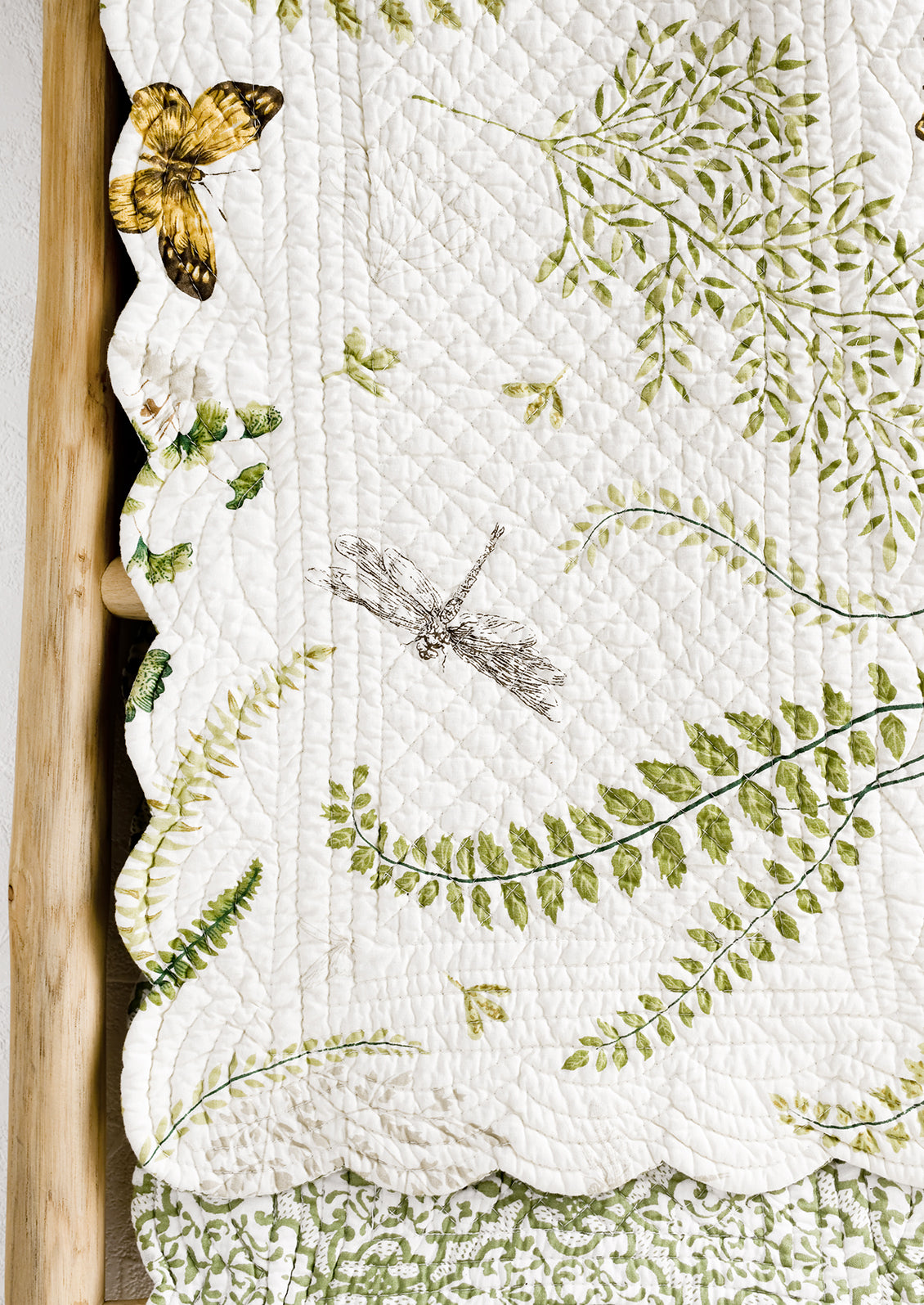 A quilted table runner with fern print.