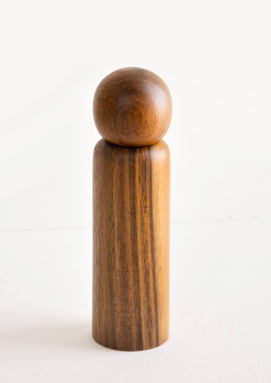 Minimal Pepper Grinder in Dark wood with spherical top.