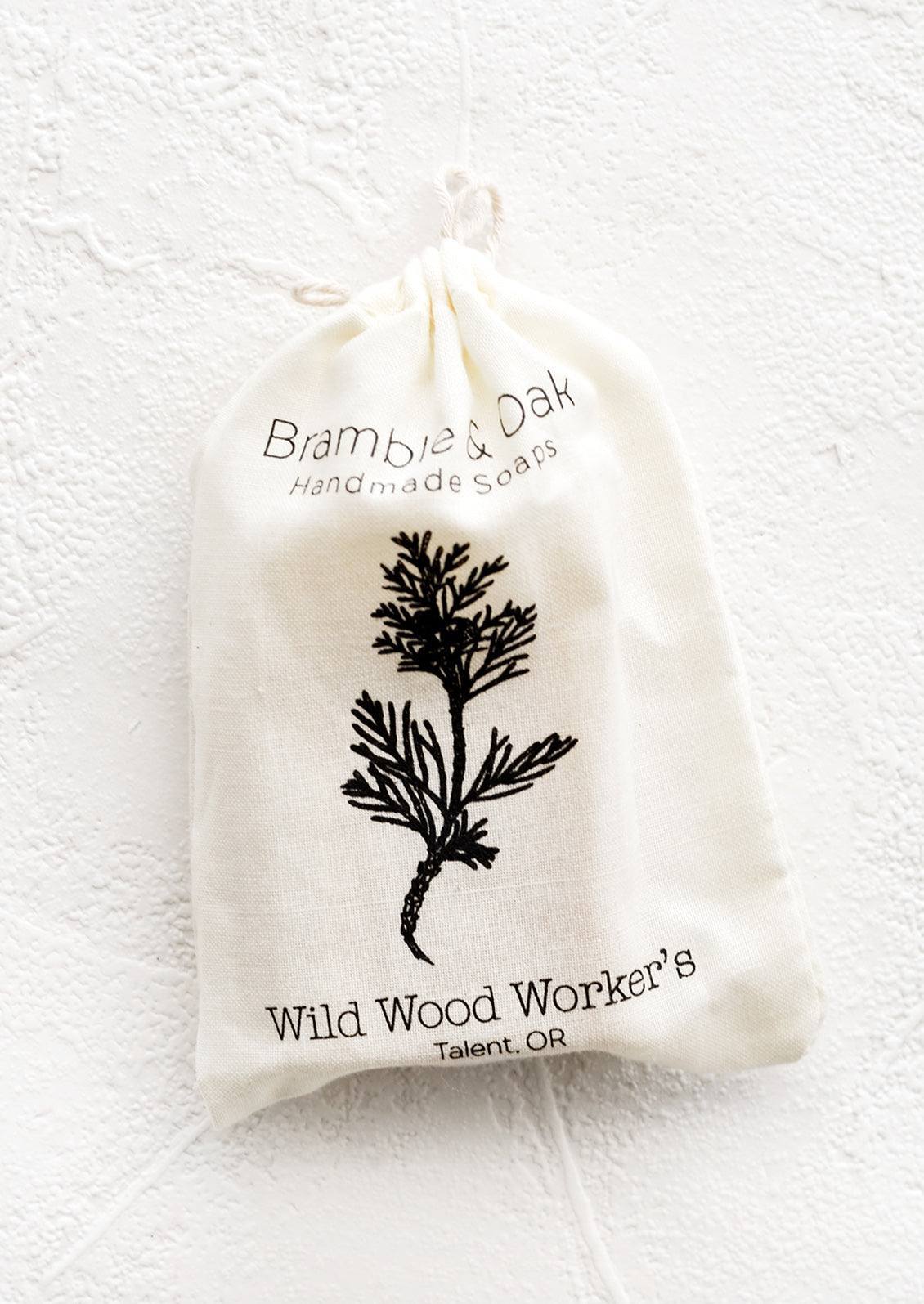A printed muslin bag with botanical imagery.