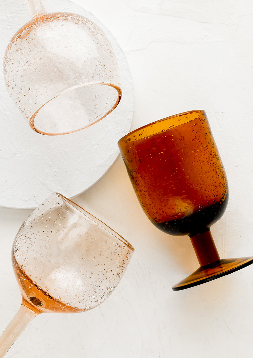 1: Rose and amber colored stemware glasses.