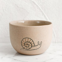 Small / Snail / Sand: A small sand porcelain cup with snail sketch.