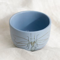 Small / Firefly / Periwinkle: A short and wide periwinkle blue cup with firefly sketch.