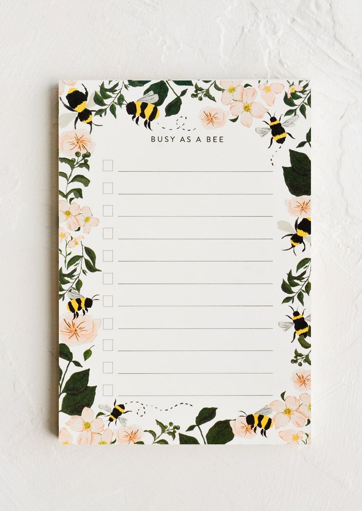 1: A task notepad with bee floral print border.