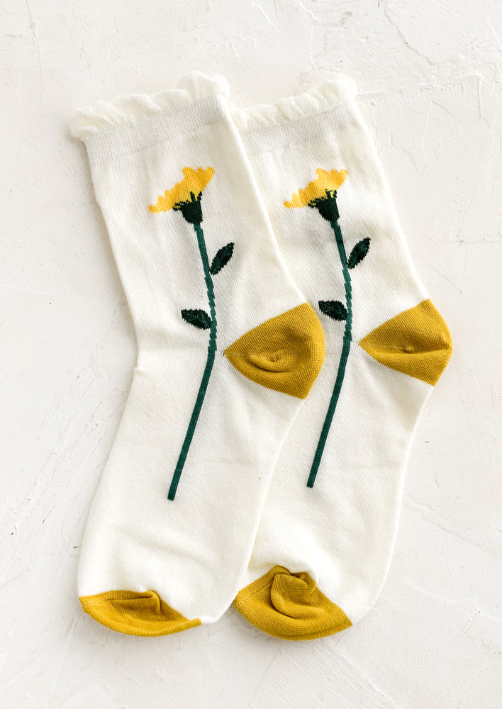 1: A pair of ivory socks with yellow buttercup design.