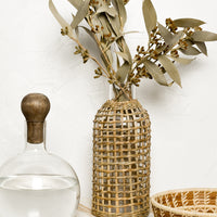 2:  A glass carafe with seagrass wrapped vase.