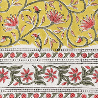 4: A block printed tablecloth in yellow, pink and green floral.