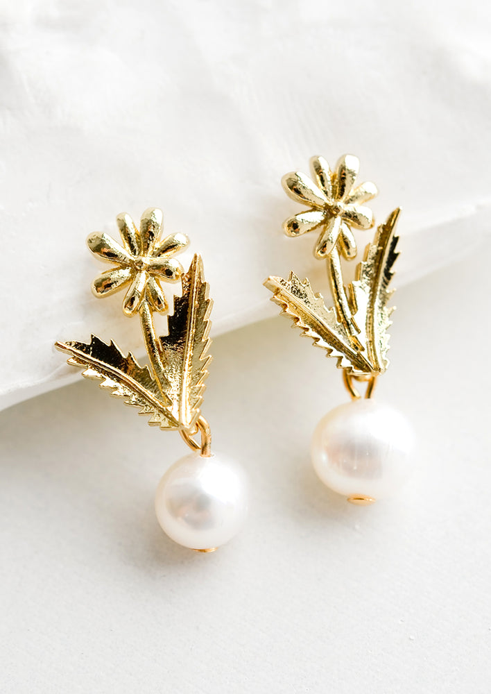 Gold flower earrings with pearl bead.