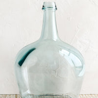 2: A large bottle shaped glass vase with blue tint.