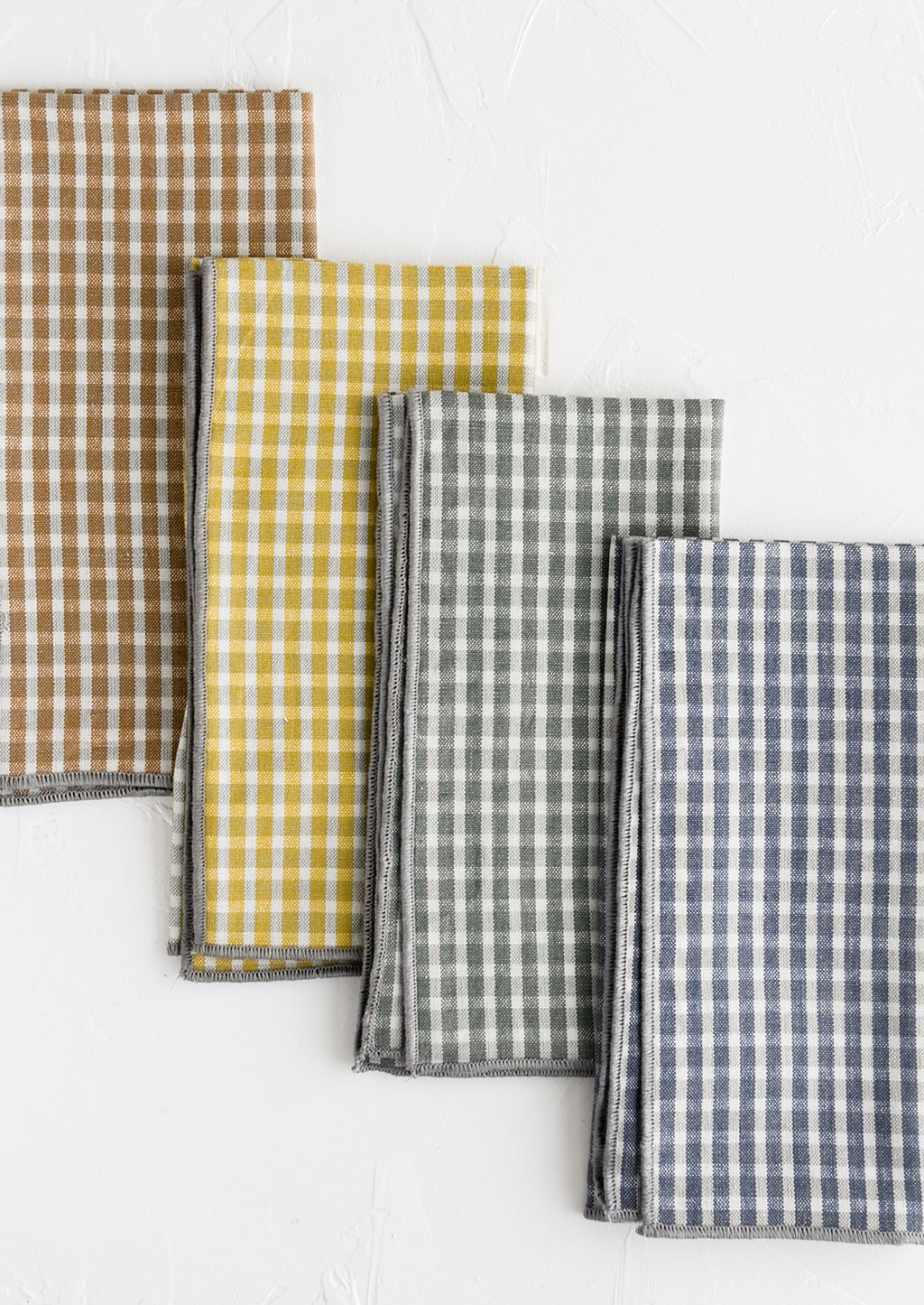2: A set of four plaid print napkins in a mix of colors.